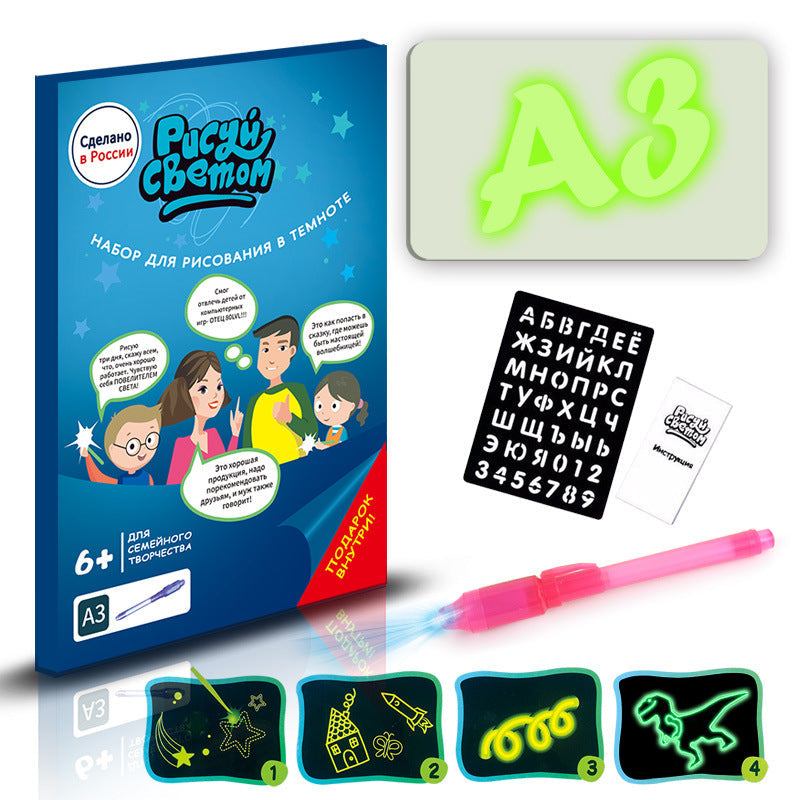 3D Magic Light-Up Drawing Pad with a glowing green A3 panel, black letter stencil, pink light pen and drawing templates
