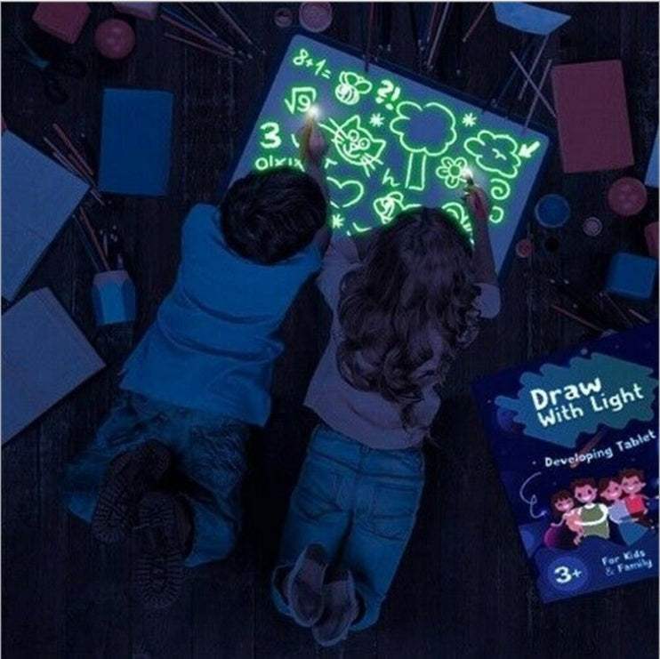 3D Magic Light-Up Drawing Pad, black plastic board glowing with bright green drawings and a light pen