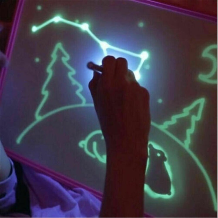 3D Magic Light-Up Drawing Pad with a purple plastic frame, glowing green and blue drawings, and a light pen