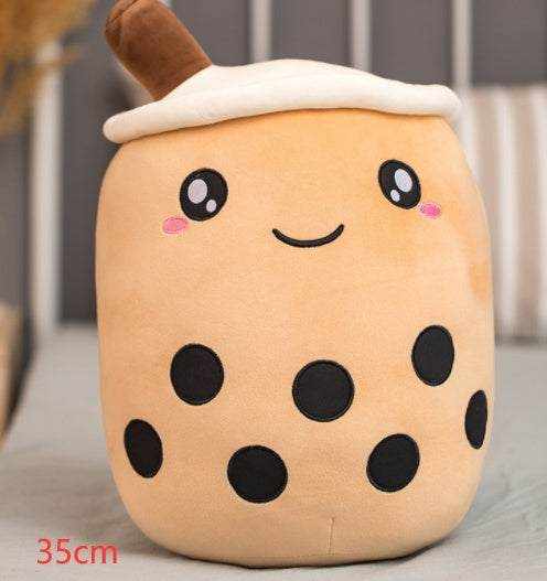 Bubble Tea Plush Pillow in caramel brown plush with a white whipped cream top, brown straw, and embroidered smiling face