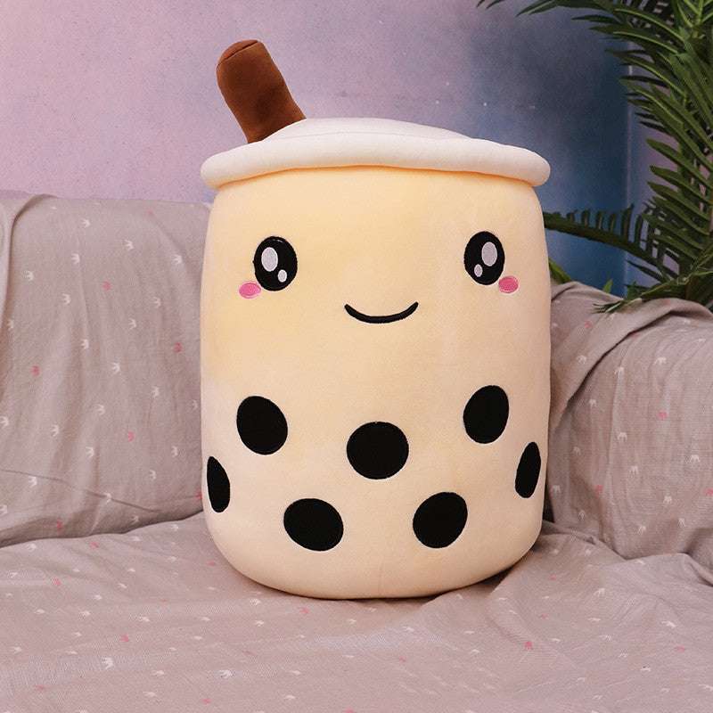 Bubble Tea Plush Pillow in a cream-colored cup shape with a white lid, brown straw, black boba dots and a cute embroidered face