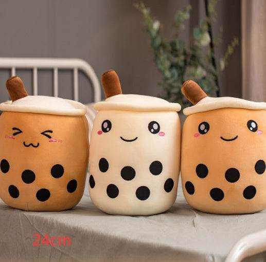 Bubble Tea Plush Pillow in orange and cream short plush, with smiling embroidered faces, white lids, brown straws and black boba dots