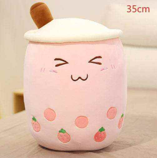 Bubble Tea Plush Pillow in pale pink plush with a white whipped-cream top, brown straw, embroidered face and strawberry details