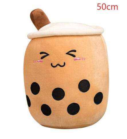 Bubble Tea Plush Pillow in tan plush fabric, with a white lid, brown straw, black tapioca pearls and embroidered face