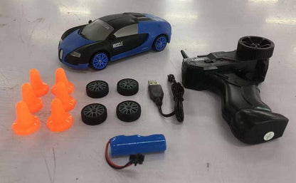 4WD RC Drift Car in blue and black with a sleek body, blue wheels, remote controller, spare tires, battery and orange cones
