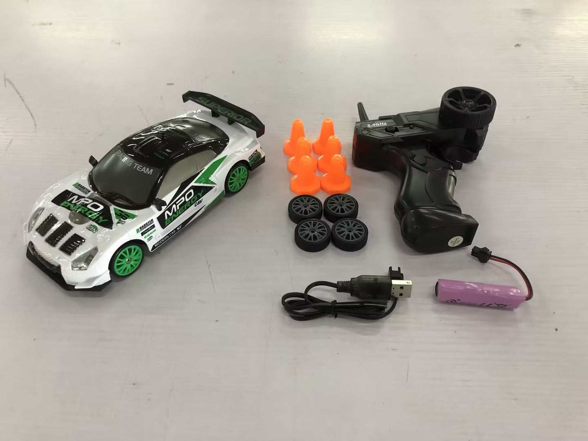 4WD RC Drift Car with a white and green racing livery, black spoiler, green wheels, remote, spare tires and cones