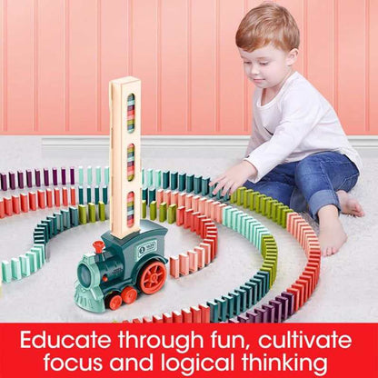 Automatic Domino Train Toy with a mint green and orange plastic locomotive placing multicoloured dominoes in winding rows