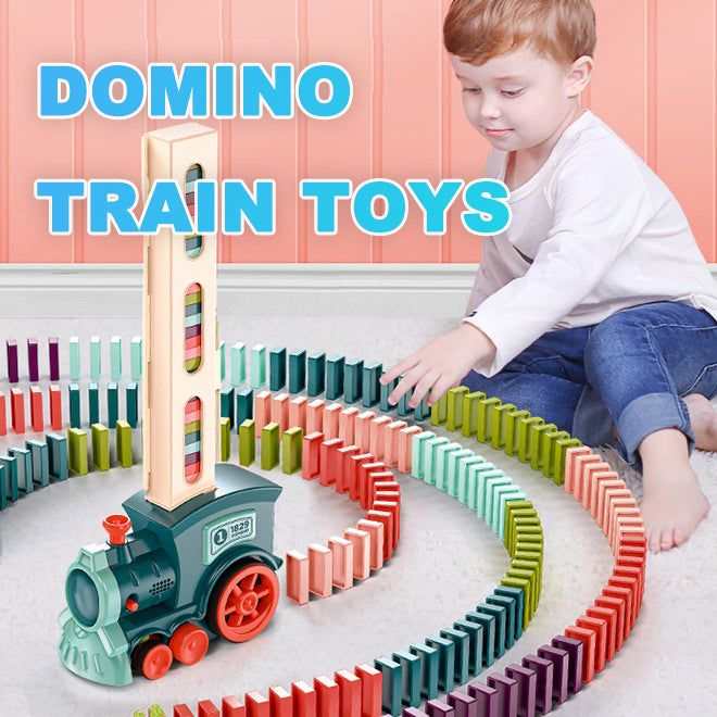 Automatic Domino Train Toy in teal plastic with red wheels, dispensing colourful dominoes into curving rows as a child plays