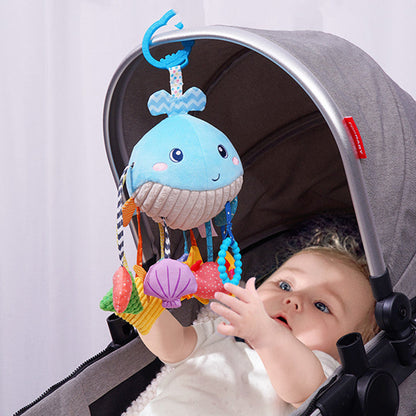 Baby Car Seat Hanging Toy featuring a soft blue whale with a smiling face, textured beige belly, and colorful dangling toys
