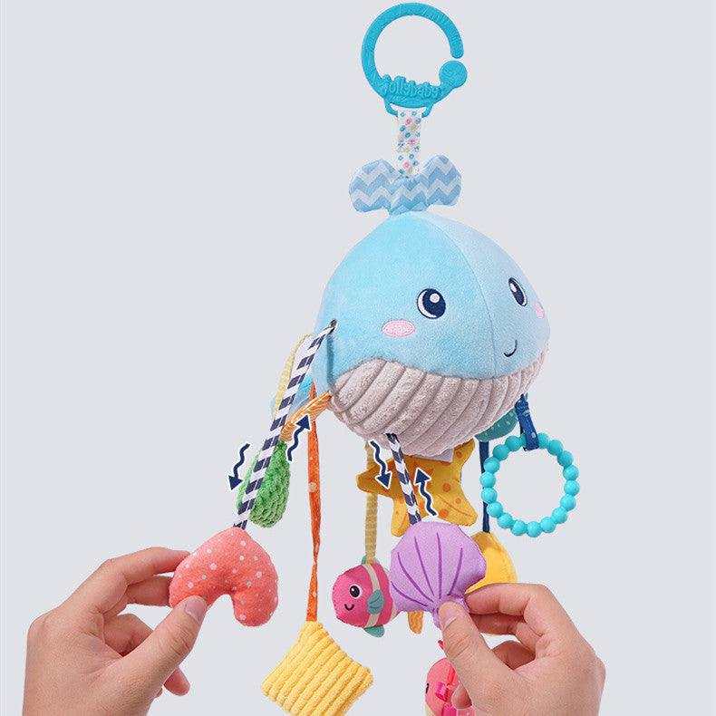 Baby Car Seat Hanging Toy in blue whale plush fabric with striped details, colorful dangling shapes and a turquoise clip