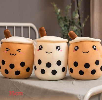Bubble Tea Plush Pillow in three cream and caramel cup designs with embroidered faces, white lids, straws and black tapioca dots