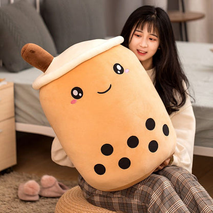 Bubble Tea Plush Pillow in caramel-colored plush fabric, topped with cream foam and featuring embroidered eyes and black tapioca pearls