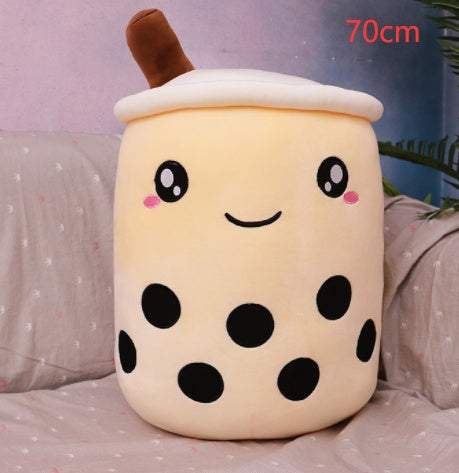 Bubble Tea Plush Pillow in cream-colored plush with a white lid, brown straw, smiling face, and black boba dots