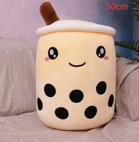 Bubble Tea Plush Pillow in cream plush fabric with black tapioca dots, embroidered smiling face, white lid and brown straw