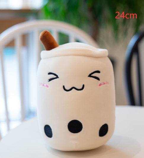 Bubble Tea Plush Pillow in a cream plush cup shape with a white lid, brown straw, embroidered smiling face and black tapioca pearls