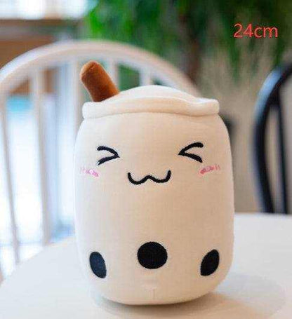 Bubble Tea Plush Pillow in a cream plush cup shape with a white lid, brown straw, embroidered smiling face and black tapioca pearls