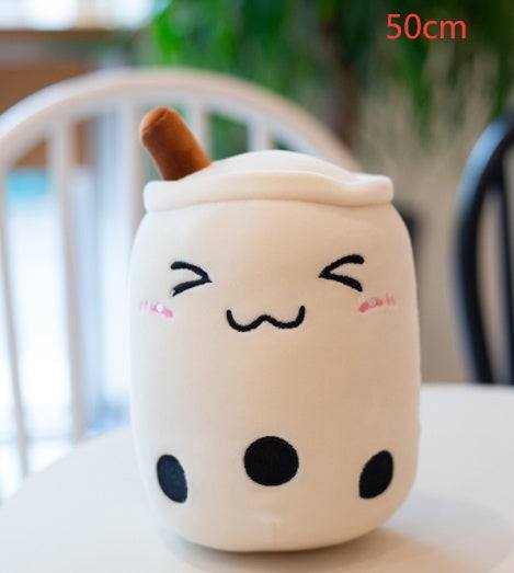 Bubble Tea Plush Pillow in a soft cream cup shape with brown straw, embroidered winking face and black tapioca pearls