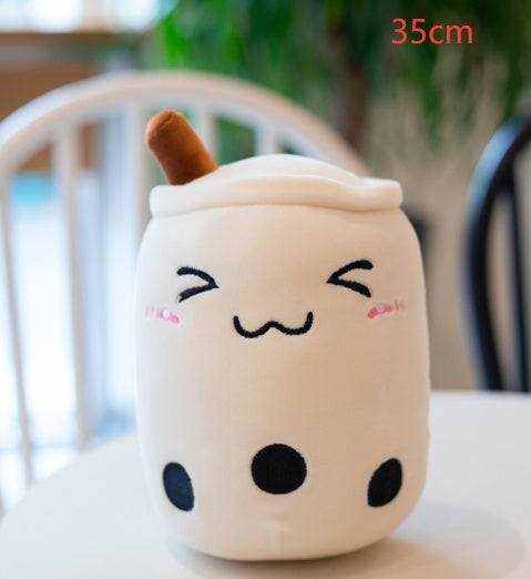 Bubble Tea Plush Pillow in a cream cup shape with a white lid, brown straw, embroidered smiling face and black tapioca pearls