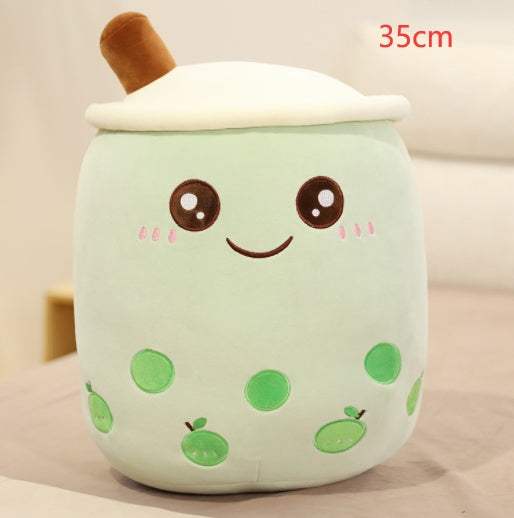 Bubble Tea Plush Pillow in pale mint-green fabric with white whipped topping, a brown straw, embroidered smiling face and green tapioca pearls