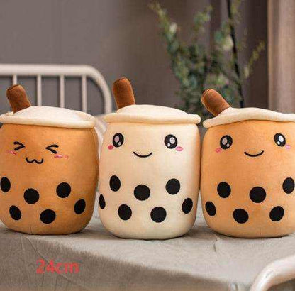 Bubble Tea Plush Pillow in orange and cream short plush, with smiling embroidered faces, white lids, brown straws and black boba dots