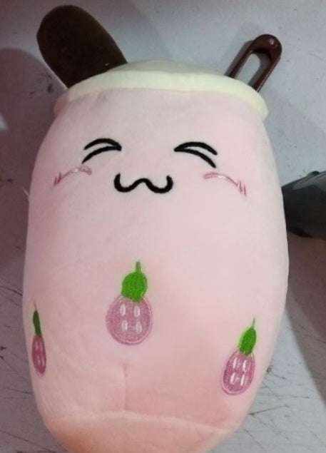 Bubble Tea Plush Pillow in soft pink plush with white lid, brown straw and embroidered smiling face and purple fruit motifs