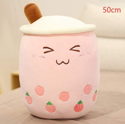 Bubble Tea Plush Pillow in pale pink plush with a white whipped-cream top, brown straw, embroidered face and strawberry details