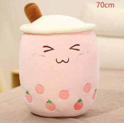 Bubble Tea Plush Pillow in pale pink plush with cream topping, brown straw, embroidered face and strawberry details