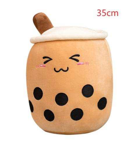Bubble Tea Plush Pillow in tan short plush, shaped like a cup with a white lid, brown straw, black tapioca dots and embroidered face