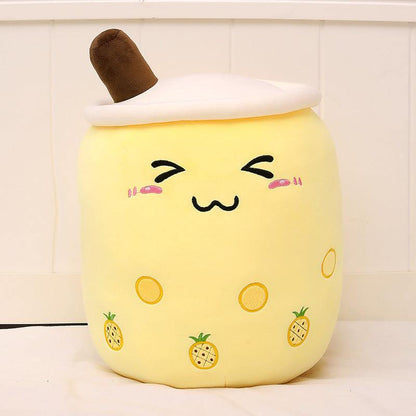 Bubble Tea Plush Pillow in pale yellow plush with a white lid, brown straw, embroidered face and pineapple motifs