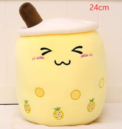 Bubble Tea Plush Pillow in yellow short plush, topped with white foam and a brown straw, with a cute face and pineapple prints