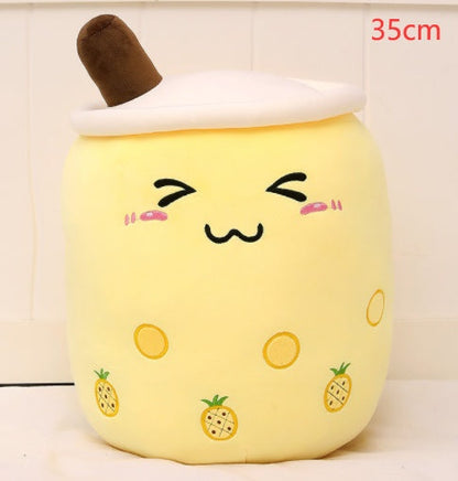 Bubble Tea Plush Pillow in pale yellow short plush, with a white lid, brown straw, embroidered face and pineapple prints