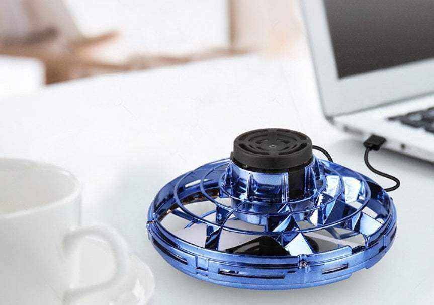 LED Fingertip Gyro Spinner Toy in metallic blue translucent plastic with a black top and open circular frame