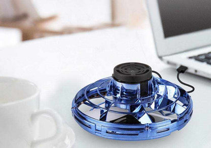 LED Fingertip Gyro Spinner Toy in metallic blue translucent plastic with a black top and open circular frame