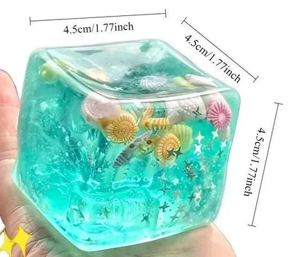 Squishy Ocean Fidget is a translucent aqua gel stress ball with embedded seashells, starfish, and ocean-themed shapes