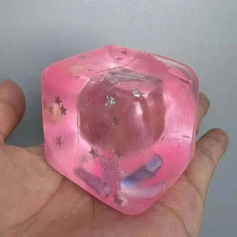 Squishy Ocean Fidget stress ball in translucent pink gel with embedded star confetti and small ocean-themed shapes