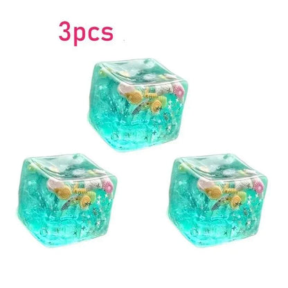 Squishy Ocean Fidget set of three translucent turquoise cube-shaped stress balls with colorful embedded sea shells and starfish